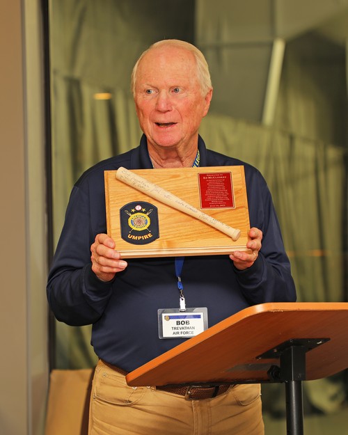 Bob Trevathan displays the appreciation plaque for Ed McCloskey.